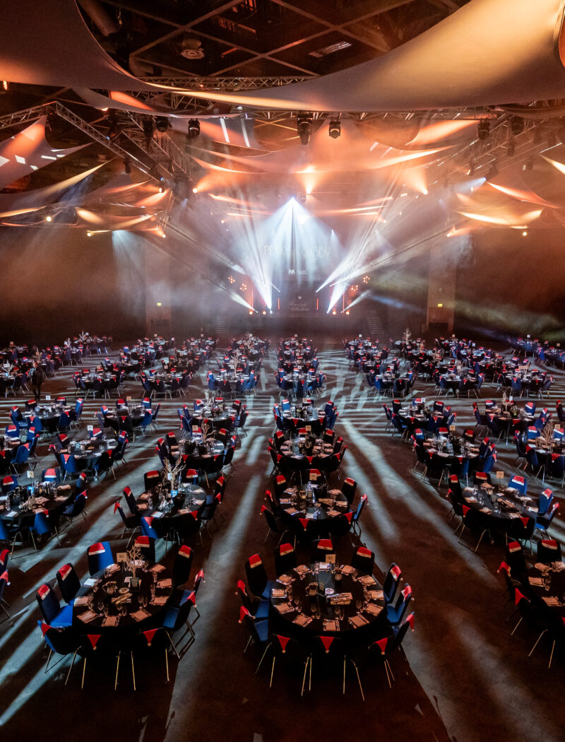 corporate gala dinner planning tips — large scale gala dinner room setup with stage lighting