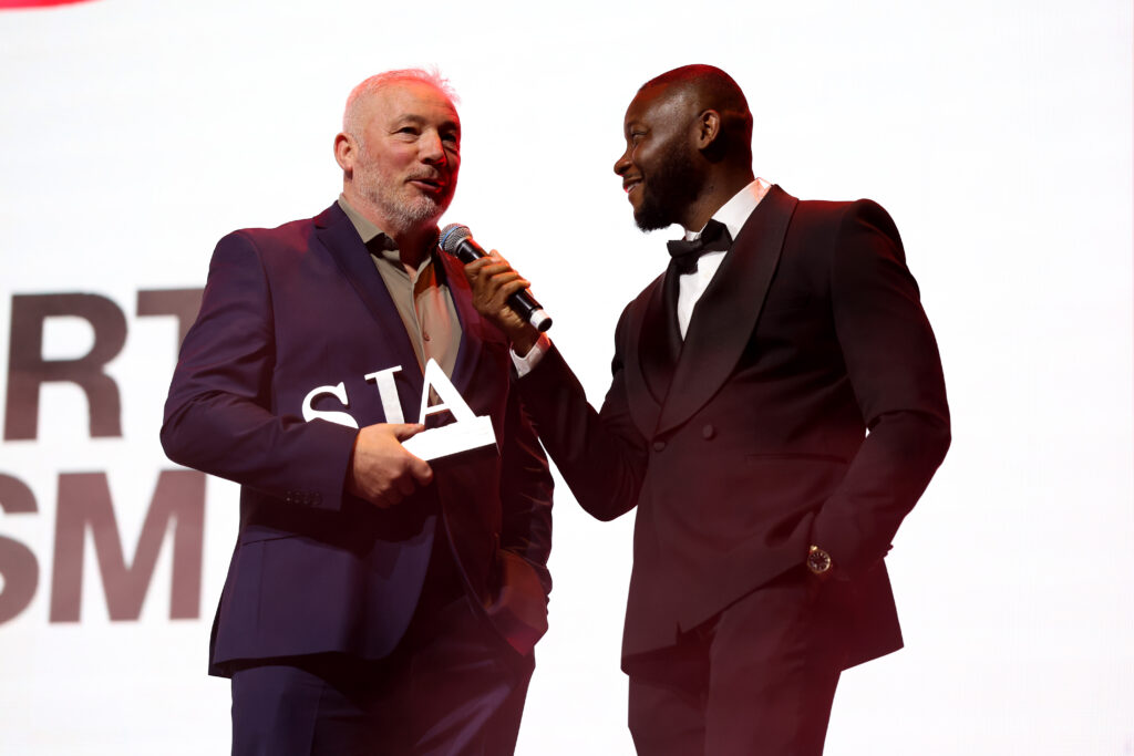 corporate awards ceremony winner receiving trophy on stage